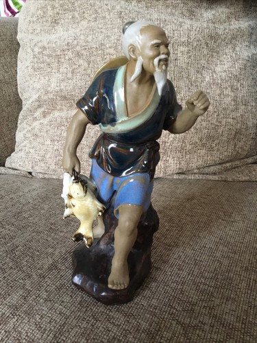 Shiwan mudman standing holding - shiwan,