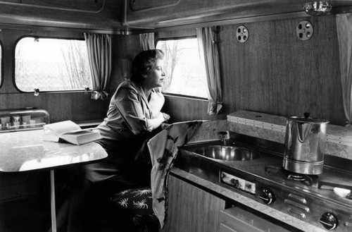 Woman sitting trailer - in, a