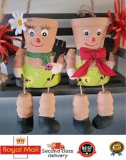 PAIR OF CHEEKY FLOWER POT MEN