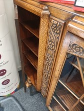 A Carved Light  Oak Bookcase With ,2 Doors  And  6 Shelves  Behind Two Glazed...