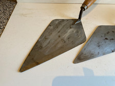 TWO SUPER BRICKLAYERS TROWELS 1 x 11"  1 x 10" WITH WOODEN HANDLES.