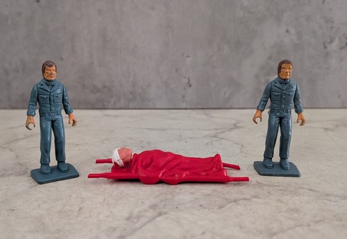 Two figures with stretcher - with,