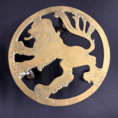 Early brass trivet rampant - brass,