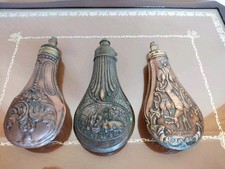 19th Gunpowder flasks in embossed copper, with a dosing spout in bronze and...