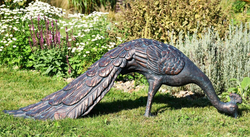 Peacock feeding garden statue