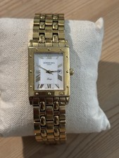 GTS Raymond weil Tango watch. Gold tone with a white dial and Roman numerals.