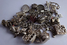 Vintage heavy solid silver charm bracelet &many curious silver charms inc moving