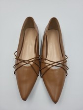 She&In point-toe flat ballet shoes with a caramel color and criss-cross straps.