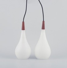 Pair of Louis Poulsen pendants in opal glass and precious wood. 1960s