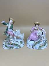 Early Staffordshire figures of a boy and girl playing with a sheep and goat.