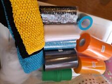 Mix of tulle fabric rolls, black/sequenced blue/sequenced orange white tube tops