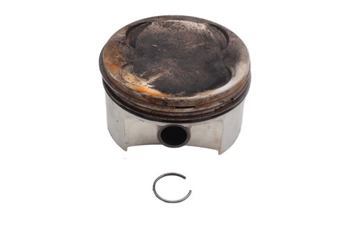 Piston with retaining ring