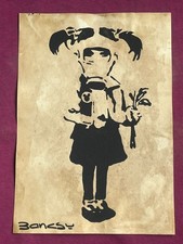 Banksy painting and drawing on