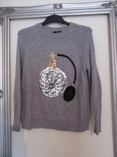 H&M ladies Grey jumper with perfume bottle on the front  size small