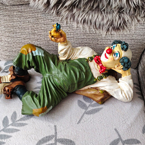 Reclining clown figurine hand - reclining,