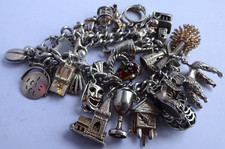Vintage heavy solid silver charm bracelet &many curious silver charms inc moving