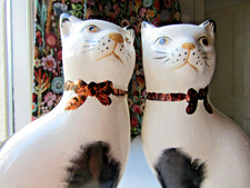 Pair Of Cat Figurines on Blue