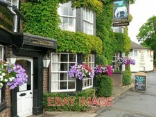 PHOTO  MAIN ENTRANCE THE WHITE HORSE WITH A NICE DISPLAY OF PETUNIAS OR SURFINIA