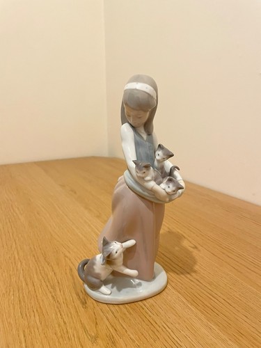 Lladro following her - cats,