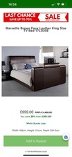 Brown leather king size bed with TV. Tv comes out with push of a button.