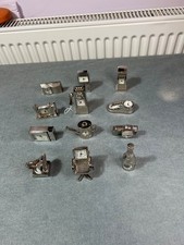 Set of 12 miniature quartz novelty clocks in silver colour. Non  working,  VGC