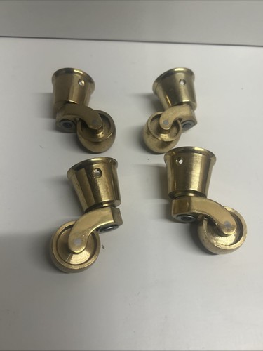 Four brass cup castors - four,