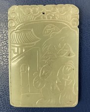 a Chinese celadon jade pendant carved with two gentlemen and text on the back