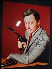 robert vaughn actor holding a