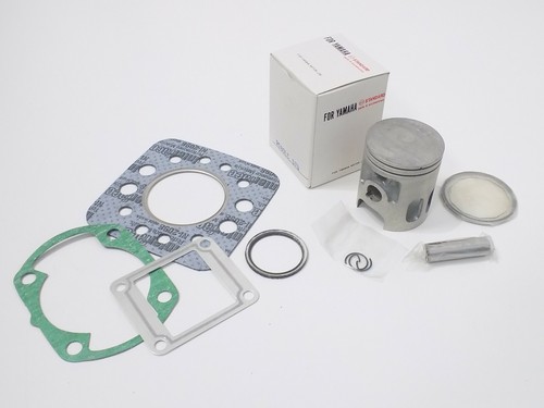 Piston and cylinder gasket set - and,