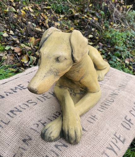 Whippet dog lying down statue