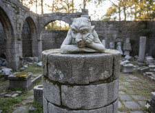 Devil head hand on chin stone