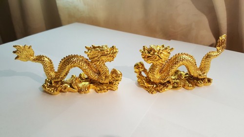 Two gold coloured small resin - two,