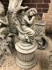 Angel on ball with plinth