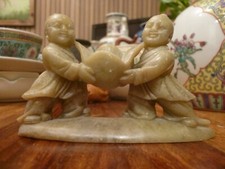TWO CHILDREN FIGURES HOLDING A