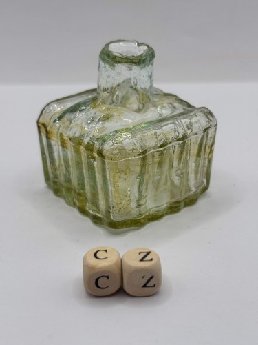 Old glass inkwell with swirls