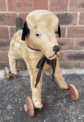 Well loved antique vintage dog - well,