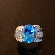 9 ct Blue Topaz Ring.  Baguette Aquamarine stones and Diamond chips on Shoulders