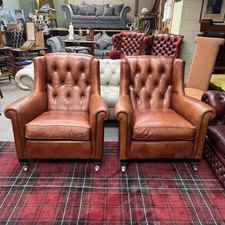 pair of used leather arms chairs