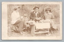 Family Picnic on Logs & Wooden Bench RPPC Cute Antique Photo—Cane (Glue) 1916