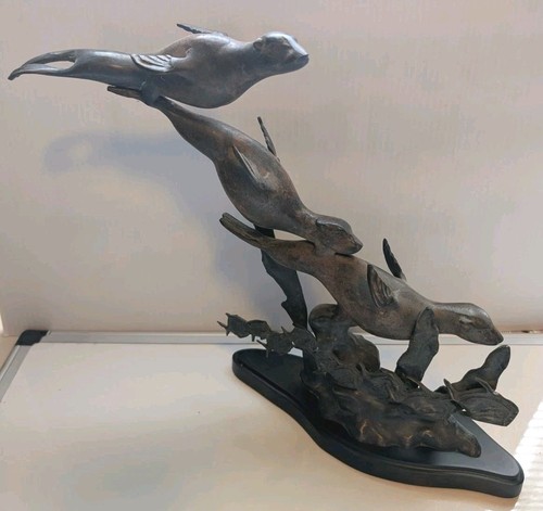 Three bronze otters diving - bronze,