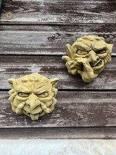 Pair of grotesque faces