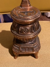 vintage, coppery metal pot belly wood stove piggy still bank