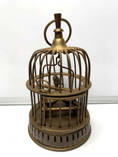 Vintage brass bird cage with bird on a perch