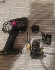 Two hpi nitro rc engines and a
