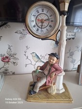 Juliana clock of a drunk leaning on a lampost