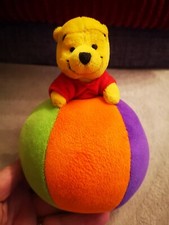 WINNIE THE POOH PLUSH SITTING ON TOP OF A CHIMING BALL. VGC