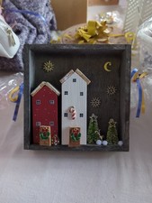 Hand Made Wooden Houses In A Wooden Frame. Christmas Theme