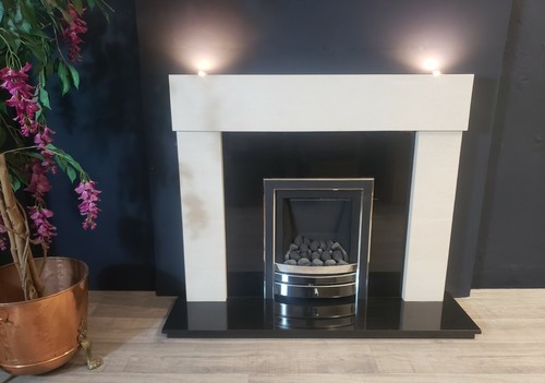 Limestone fireplace with black - fireplace,