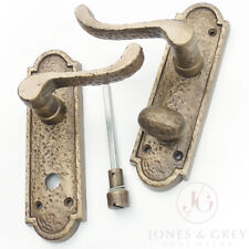 PAIR OF ANTIQUE AGED BRASS HAMMERED SCROLL LEVER LOCK DOOR HANDLES ON BACK PLATE