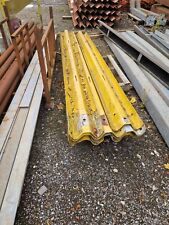 Used armco motorway crash barrier painted yellow